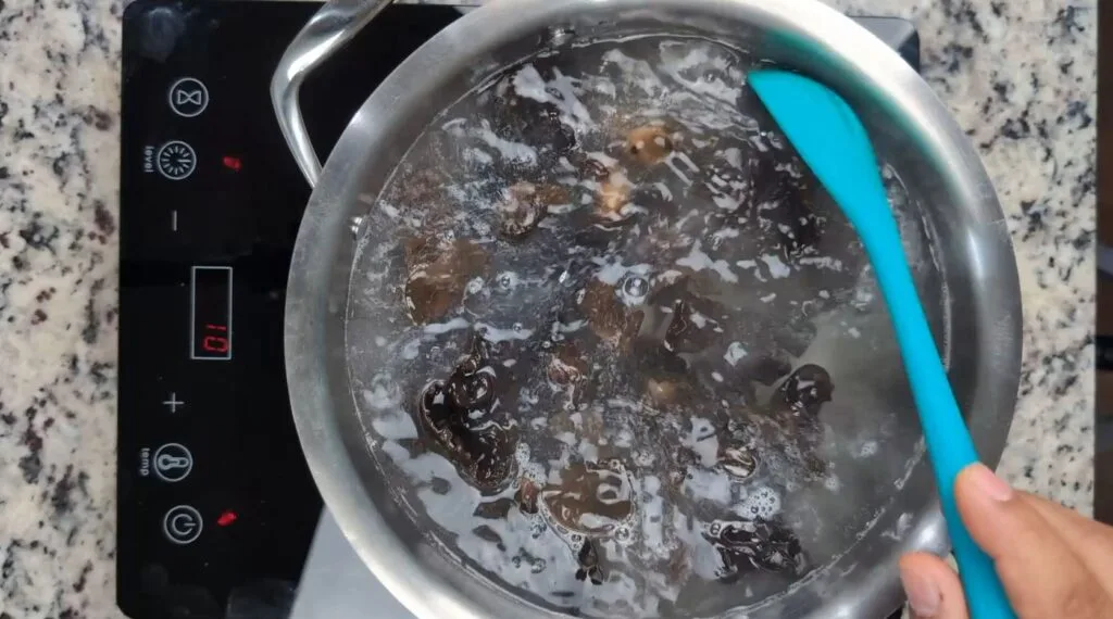 boiling wood ear mushrooms in a stainless steel pot