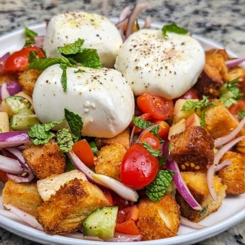 Burrata Panzanella salad on a white plate