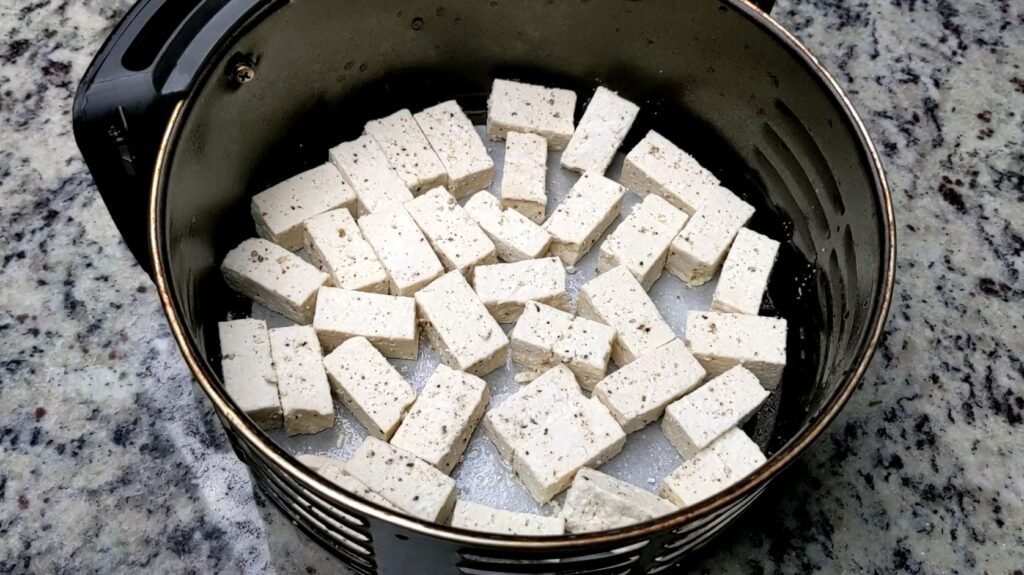 Tofu in Air Fryer Bucket Before Frying