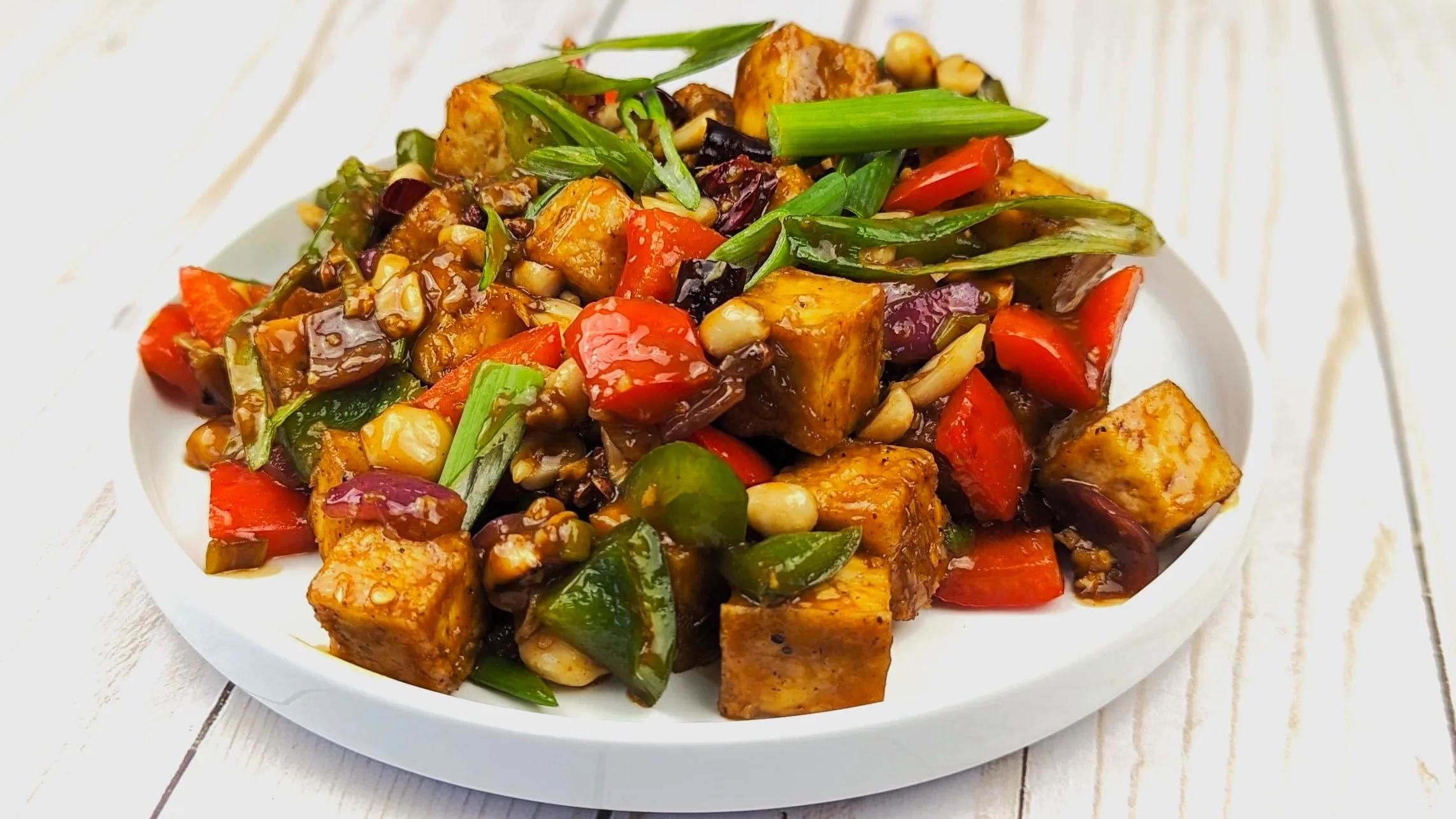 Kung Pao tofu served on a white plate