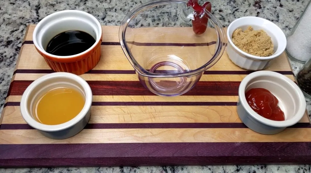 Adding ingredients in a cup to make sweet and sour sauce