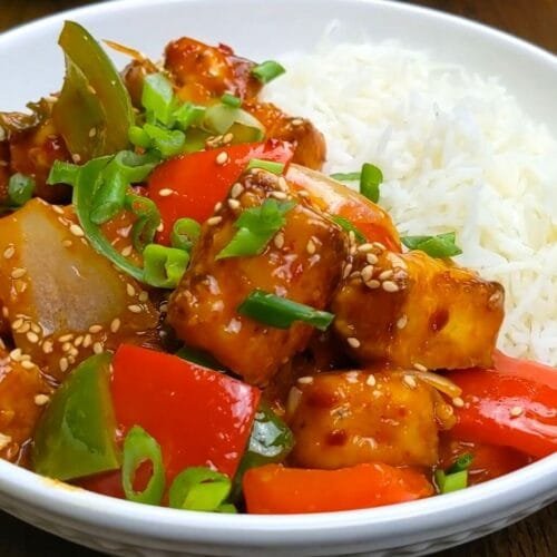 Chili Paneer with a side of Rice in a White Bowl