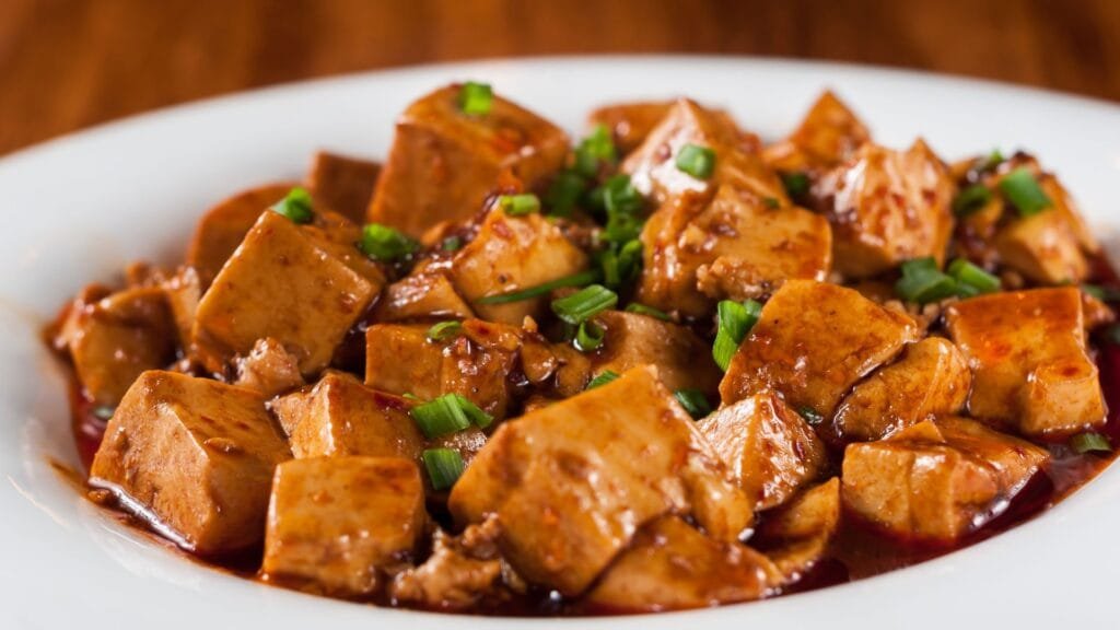 Cooked Tofu with scallions in a White Bowl