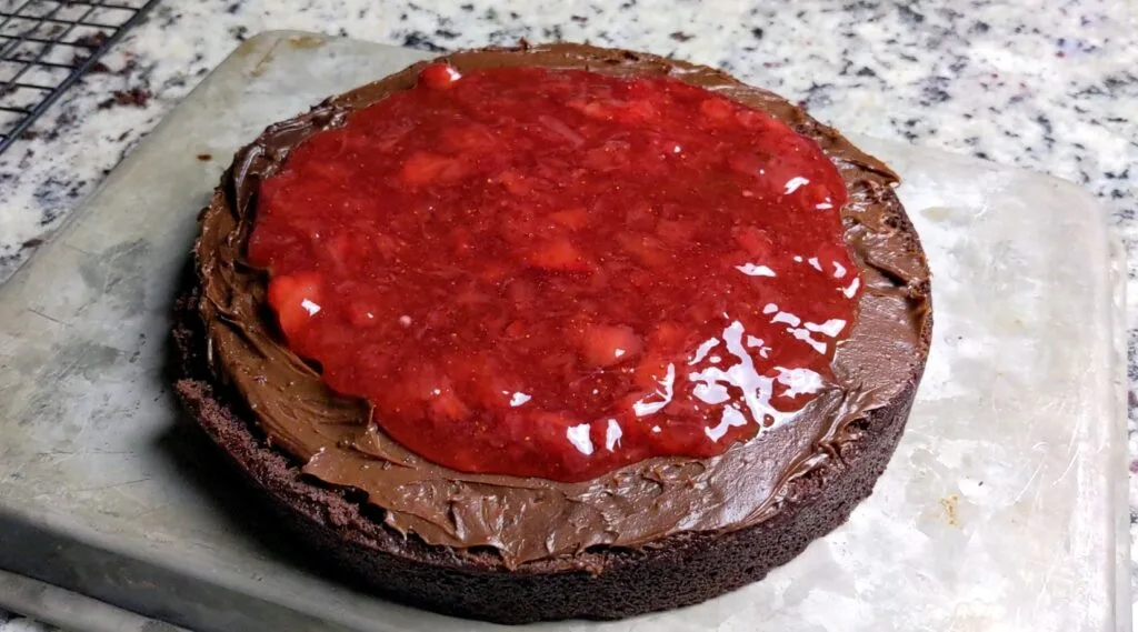 decorating cake with raspberry jam