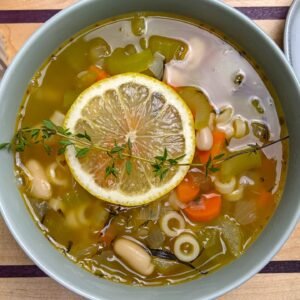 White Bean Pasta Soup served in a bowl with croutons on the side