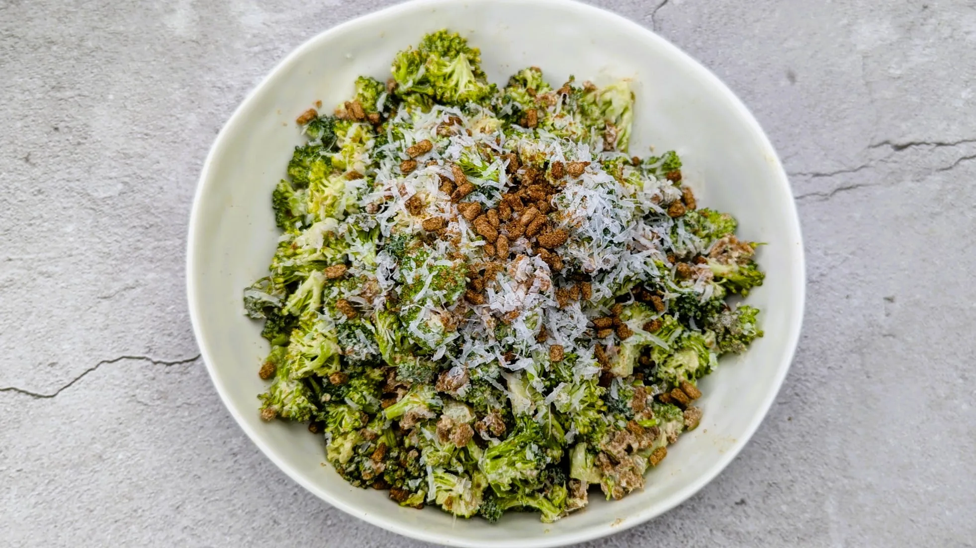 Broccoli Caesar Salad served in a white bowl
