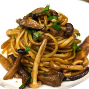 Mushroom Wafu Pasta in soy butter sauce served on white plate