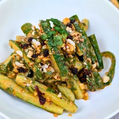 Peanut and Chili Oil Cucumber Salad served in a white bowl