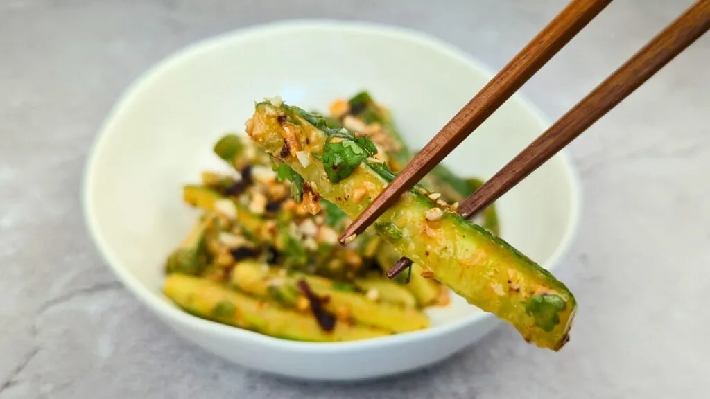 Peanut & Chili Oil Cucumber Salad served in a white bowl