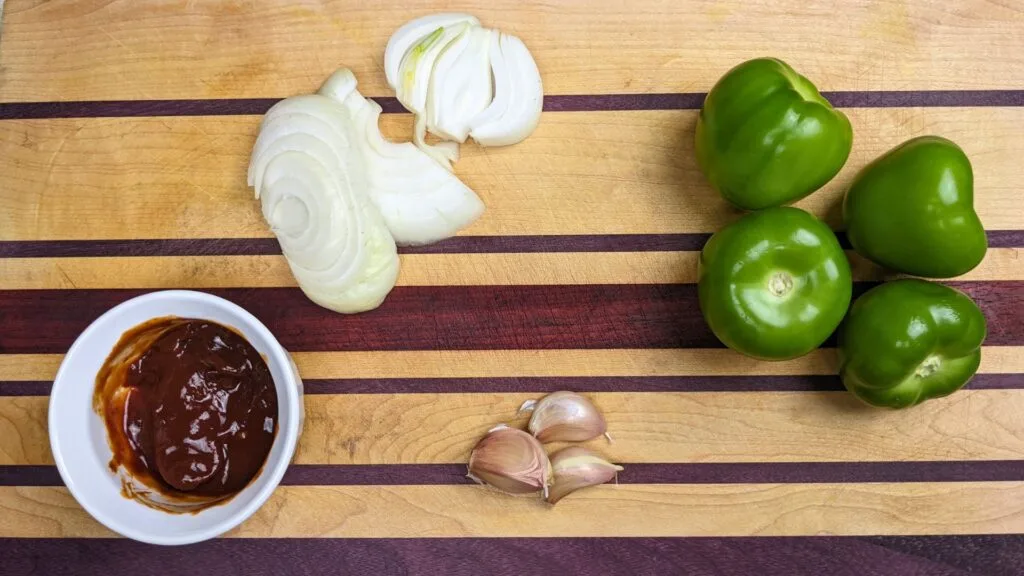 Roasted Tomatillo Salsa ingredients on a cutting board