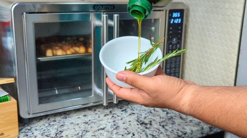 adding oil oil to the rosemary