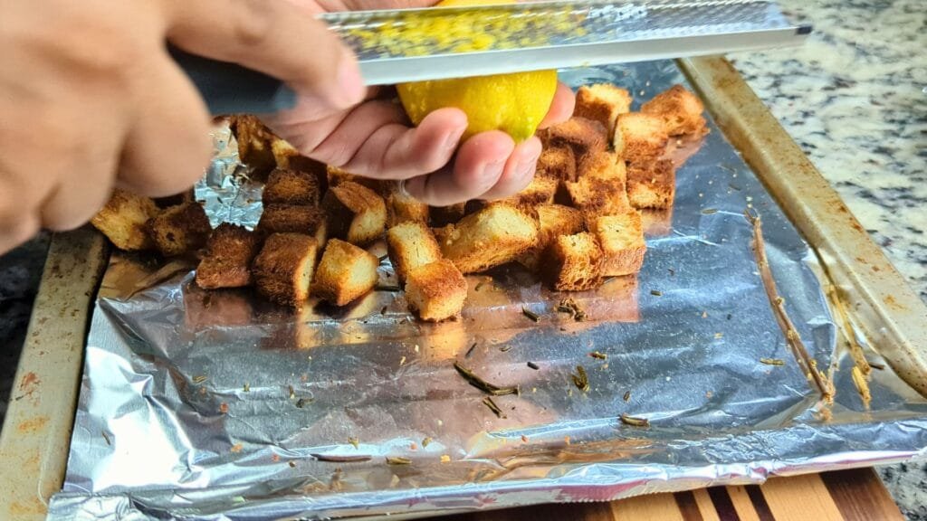 adding lemon zest to the croutons