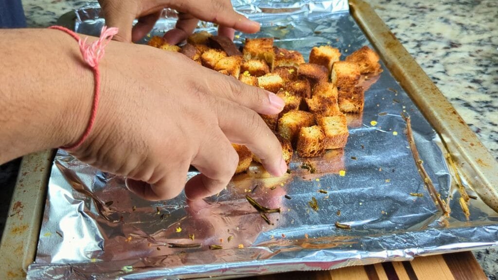 Crush Rosemary and mix the Croutons