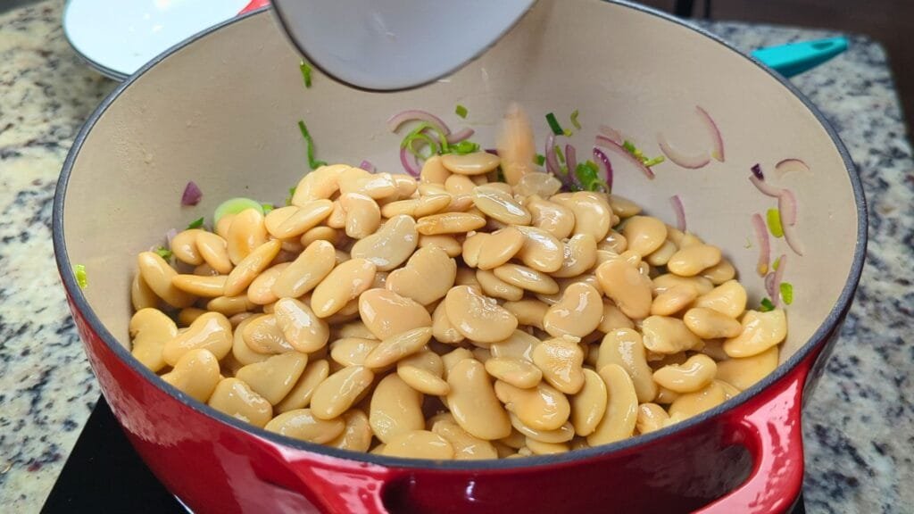 adding butter beans to the pot