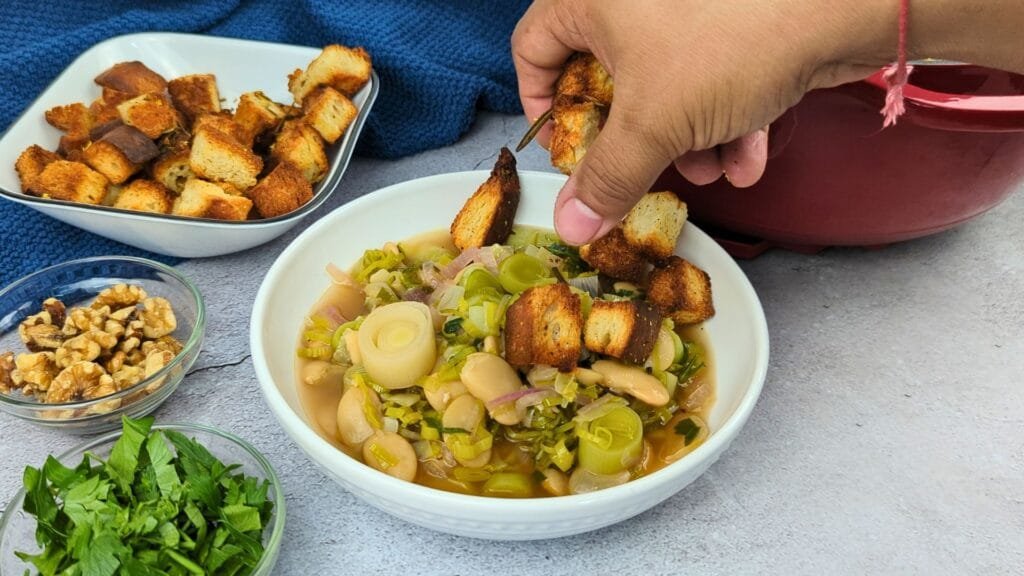 adding Rosemary Croutons to Leek and Butter Bean Soup