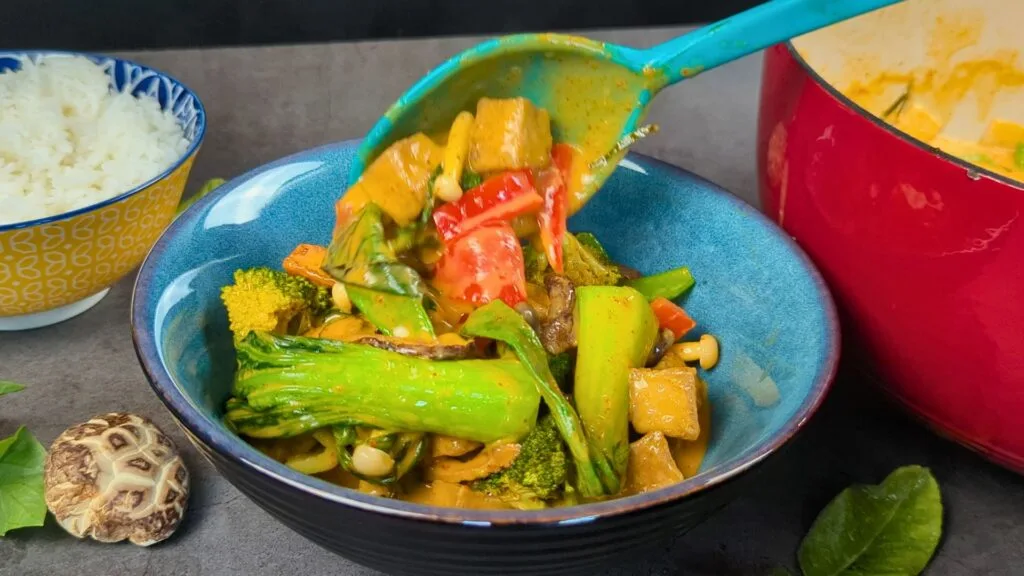 Vegan Panang Curry with Air fried Tofu served in a blue bowl