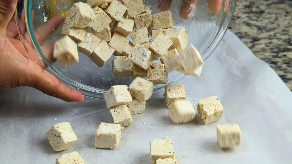 adding Tofu cubes to baking sheet
