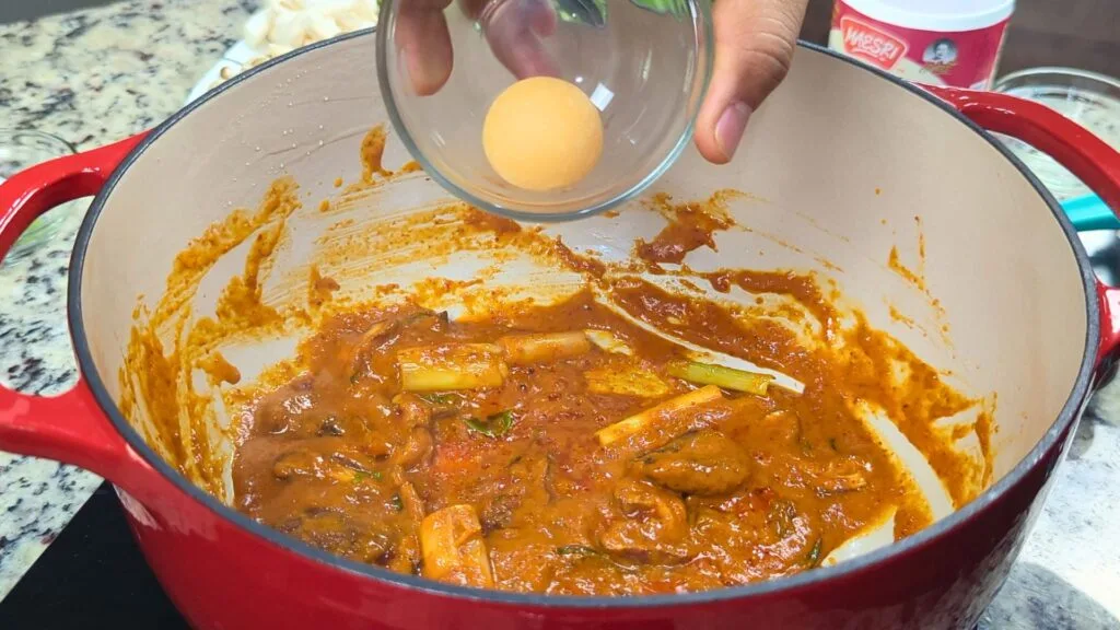 adding palm sugar to the curry
