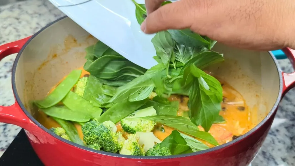 add basil leaves to the curry