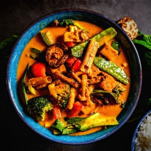 Vegan Tofu Panang Curry with Mushrooms and vegetables in a blue bowl