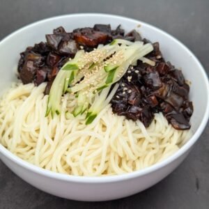 Jjajangmyeon is served in white bowl