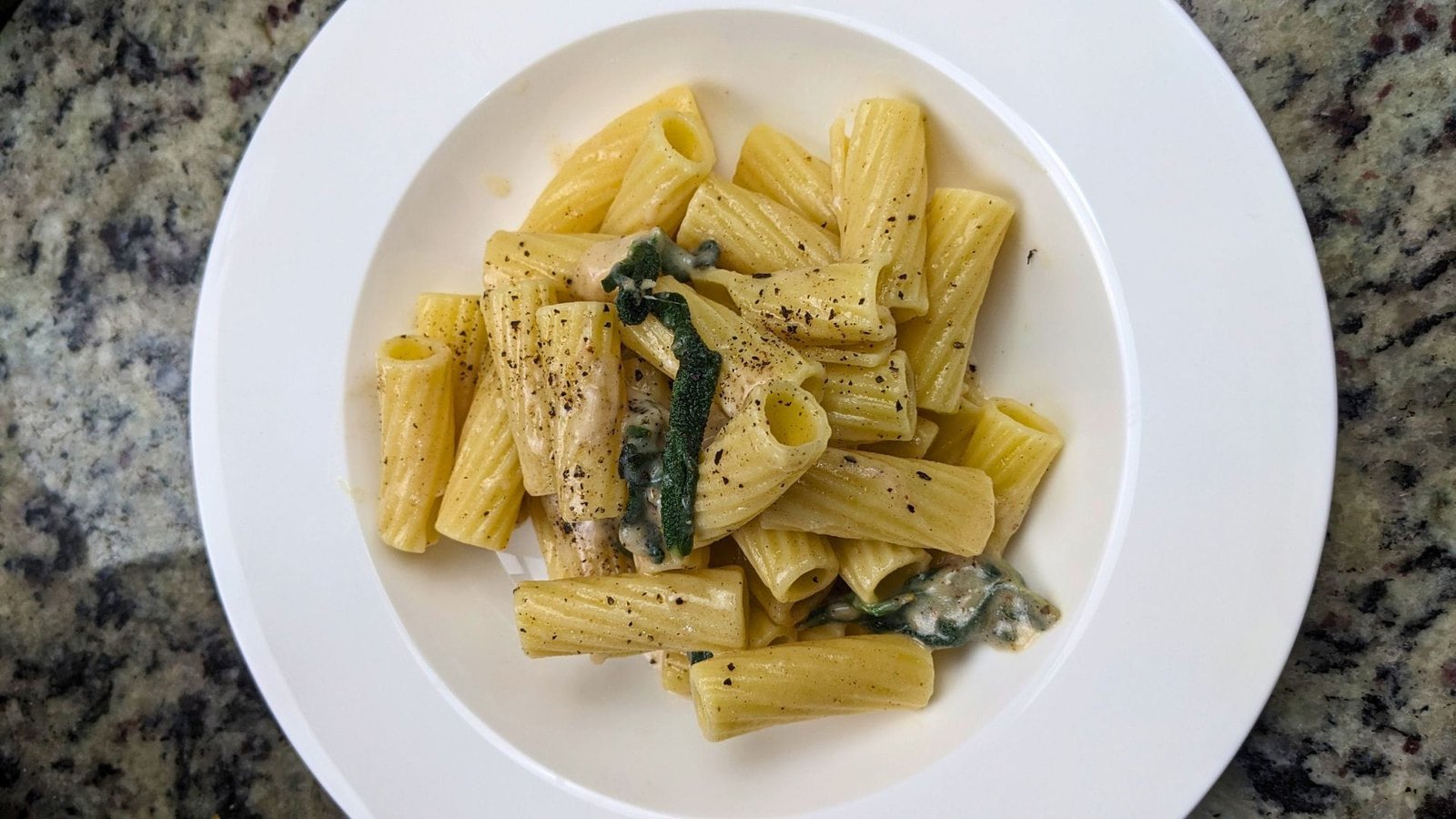 Brown Butter and Sage Pasta with Rigatoni served in a white plate