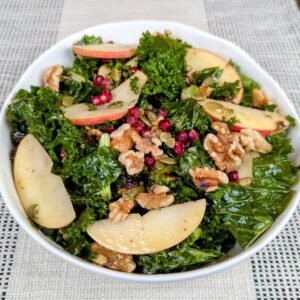 Kale Salad with Apples and Walnuts in a white bowl