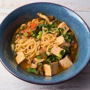 Tom Yum Ramen Noodle soup served in a blue bowl