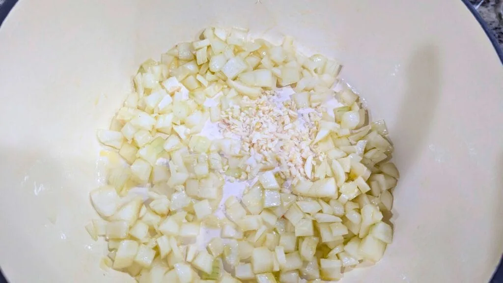 adding Onions and Garlic in a hot Dutch Oven
