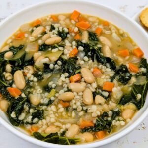 Tuscan Bean and Barley Stew with Kale served in a white bowl
