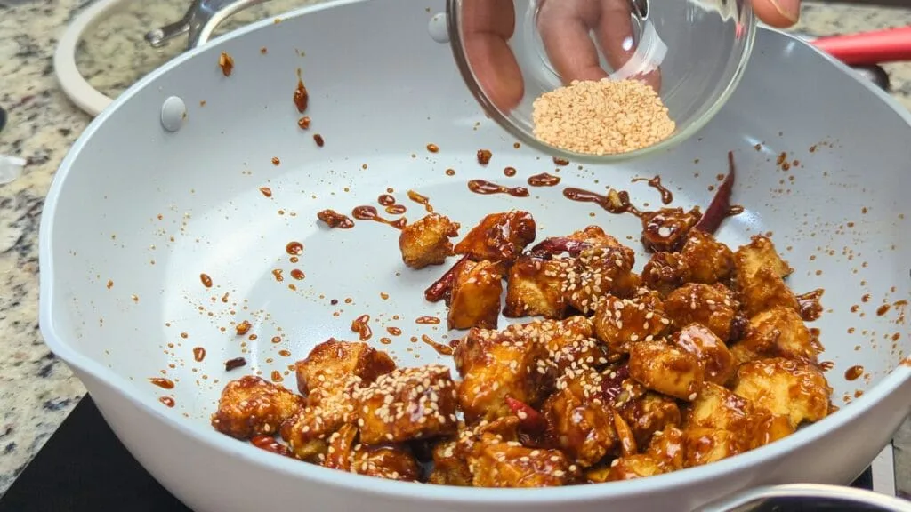 adding Sesame Seeds to the Tofu