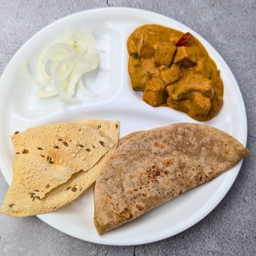 Cashew Paneer Kadhai Served with Roti and Pickled Onions