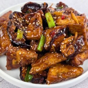 Crispy Eggplant & Tofu Stir Fry served in a white plate