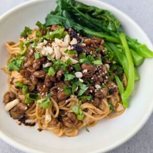 Tempeh Dan Dan Noodles is served in a white plate.