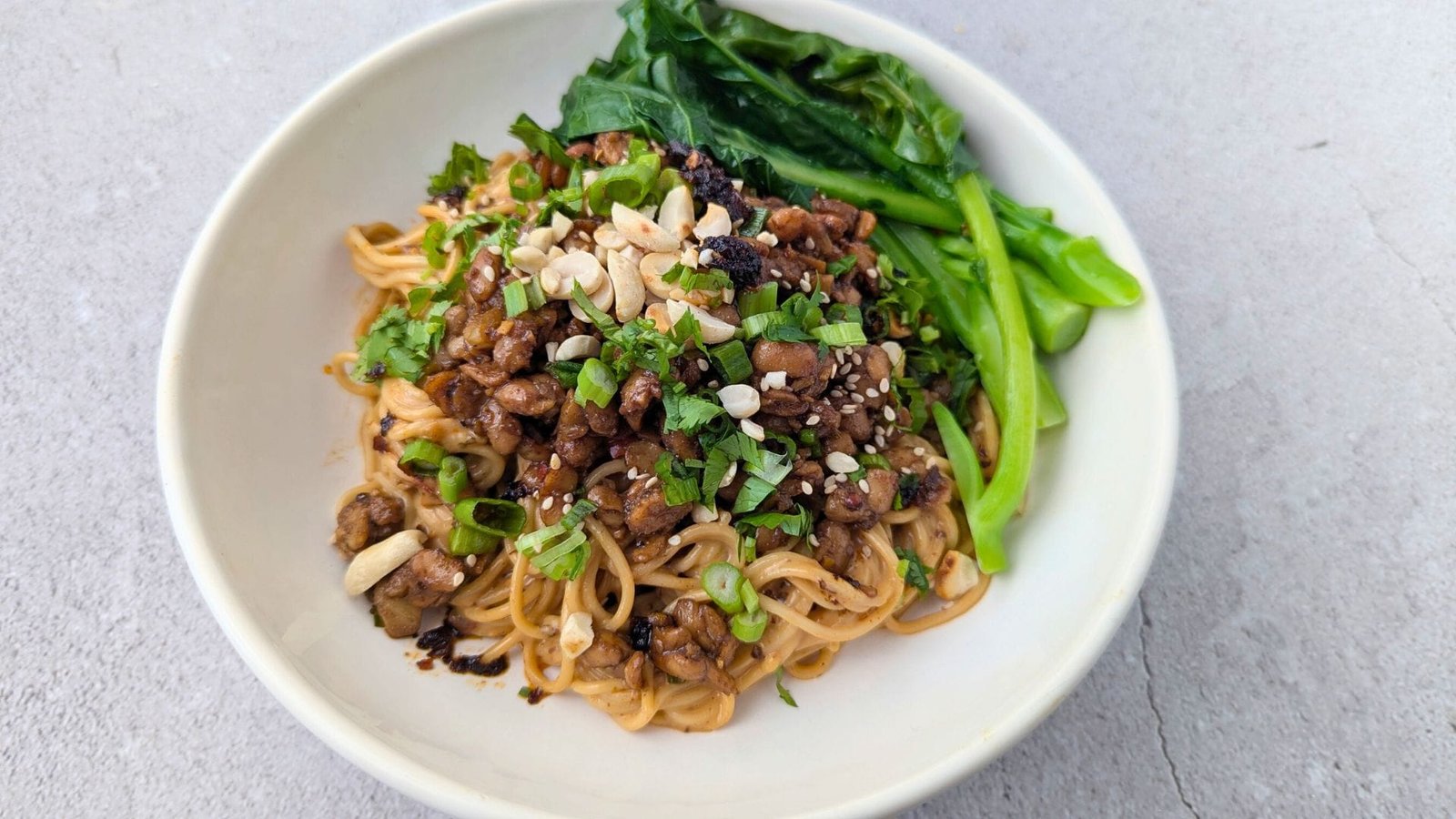 Tempeh Dan Dan Noodles is served in a white plate.