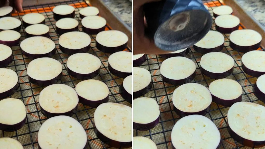 adding salt on the cut eggplants