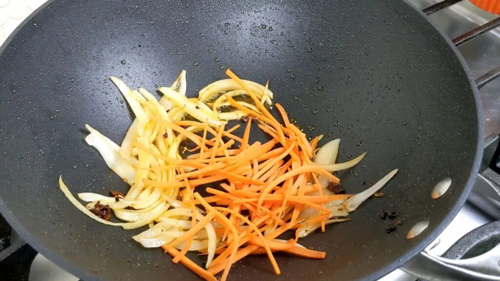 Adding Carrots to the wok