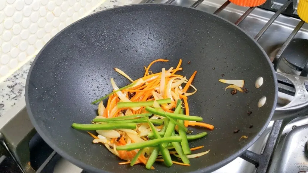 Adding Green Bell Pepper to the wok
