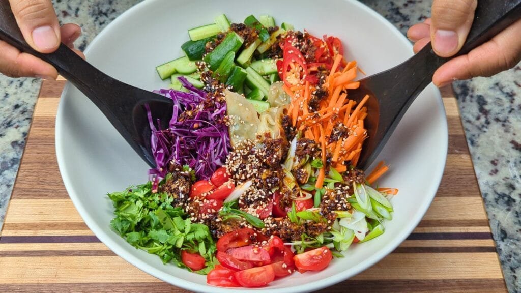 gently mixing the salad
