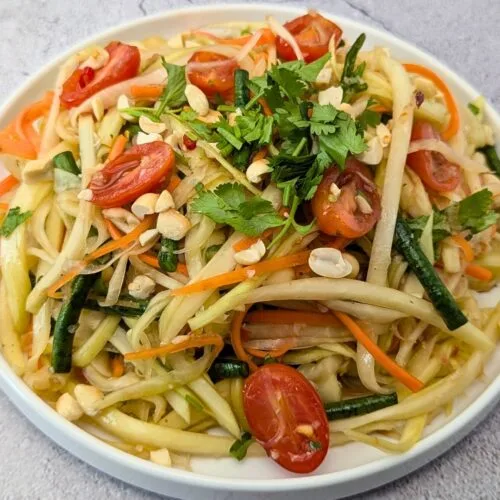 Vegan Papaya Salad served in a white plate