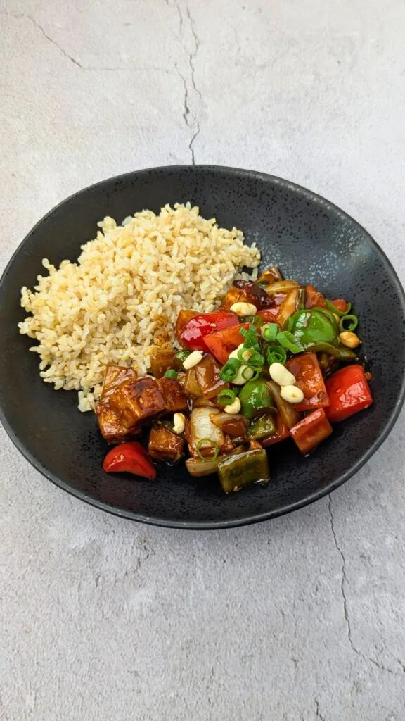 Spicy Peanut Tofu served with Brown Rice vertical image