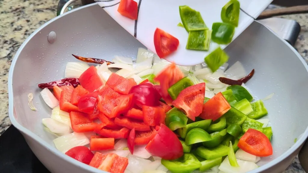 add Bell peppers to the hot wok