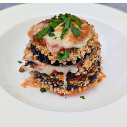 Crispy Eggplant Parmesan is ready and served in a White plate